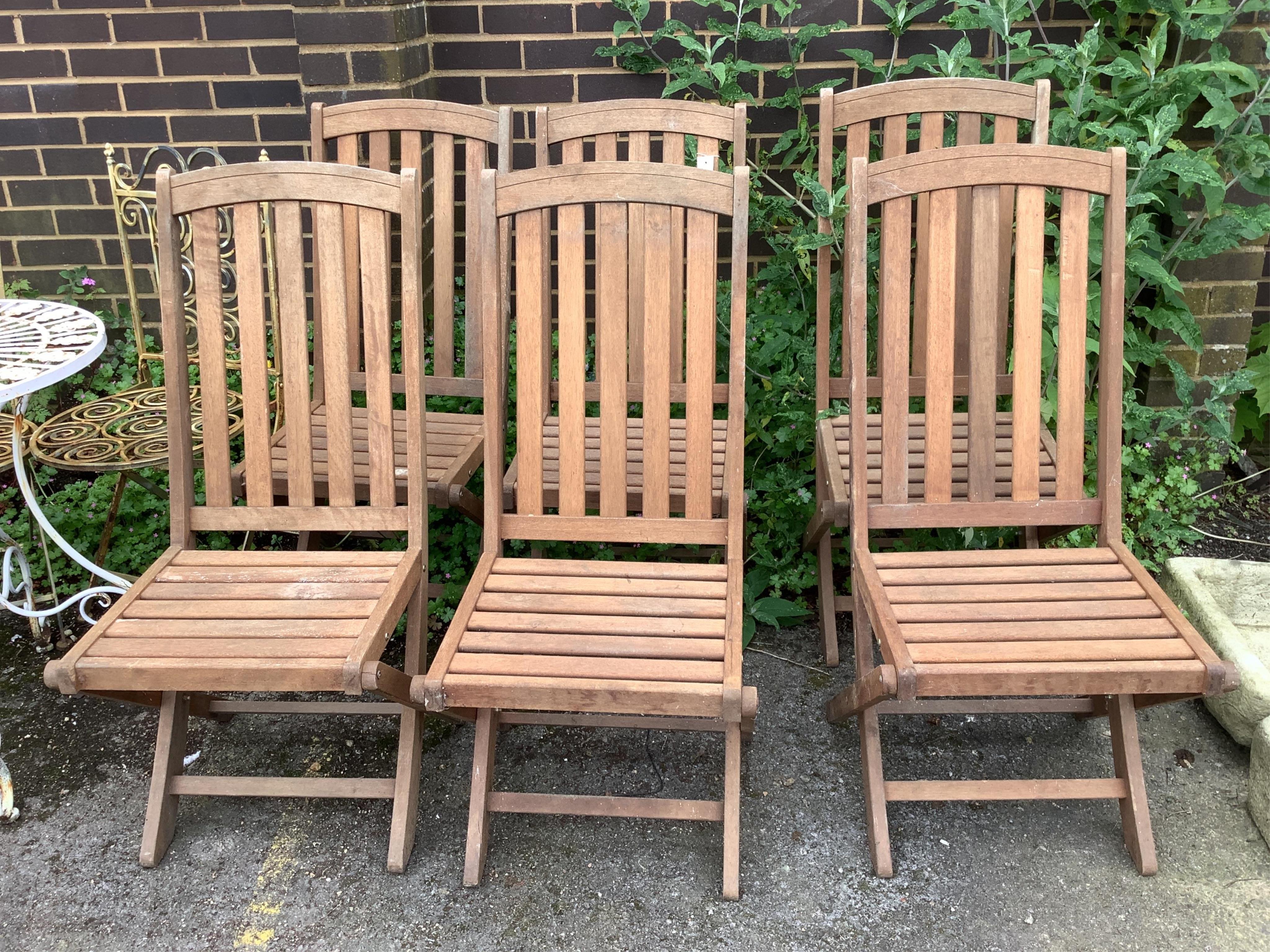 A set of six weathered teak slatted garden chairs, width 43cm, depth 52cm, height 102cm